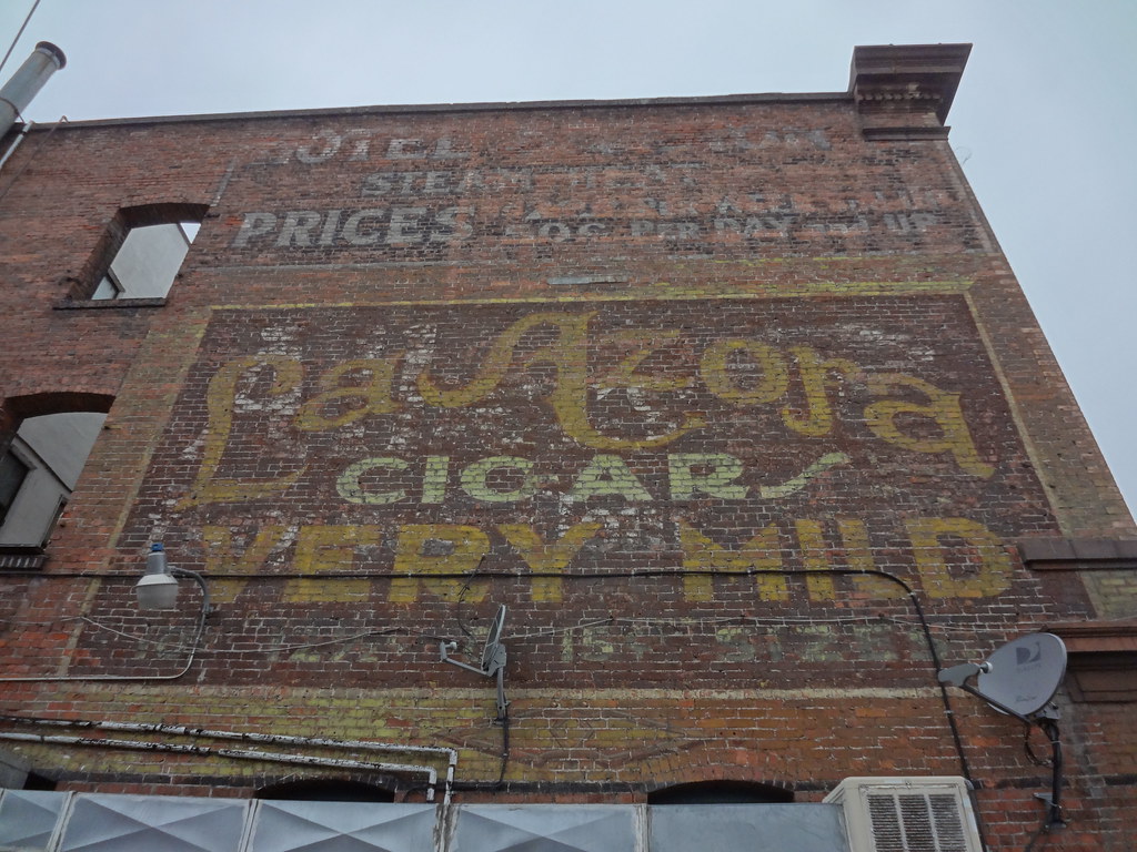 Painted vintage cigar advertisement on a brick building